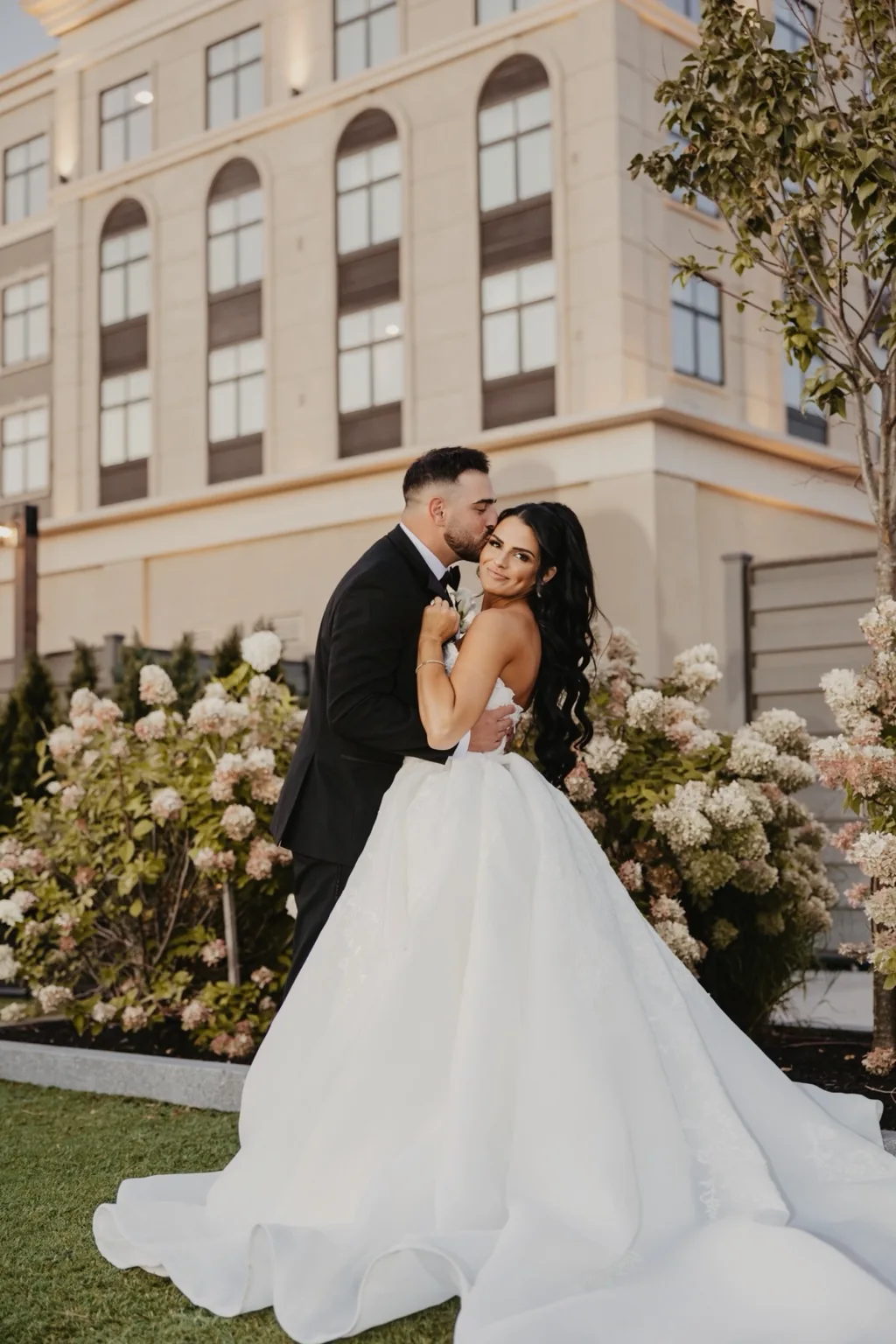 Newlyweds sharing a moment outside their wedding venue