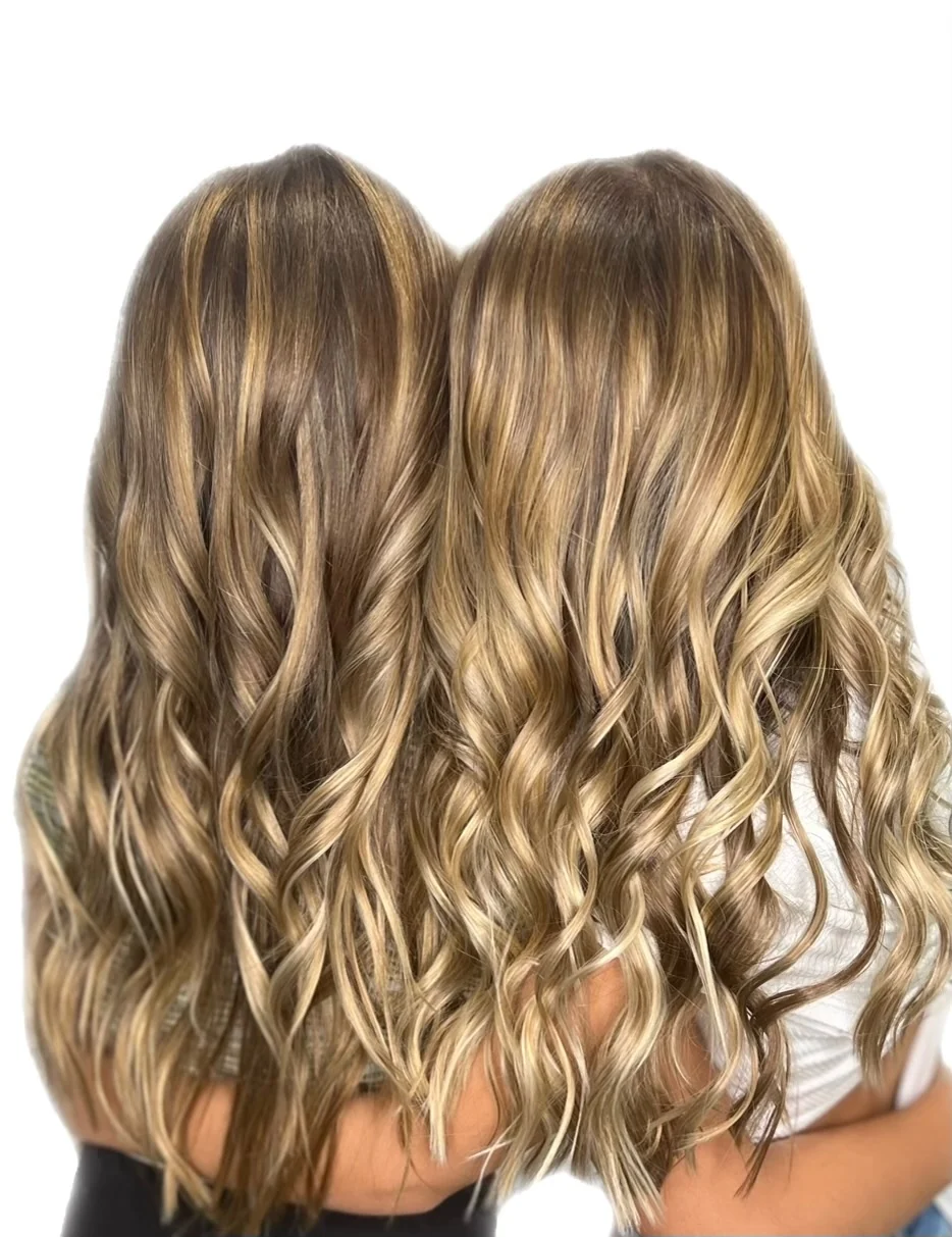 Dimensional blonde hair styled in polished waves