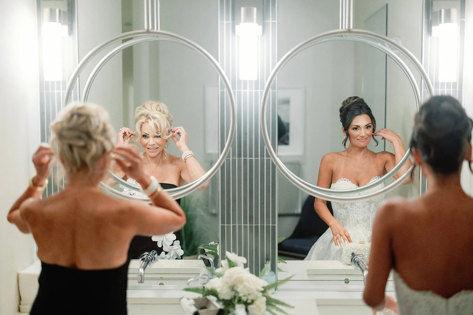 Bride and wedding party getting ready together in a bright suite