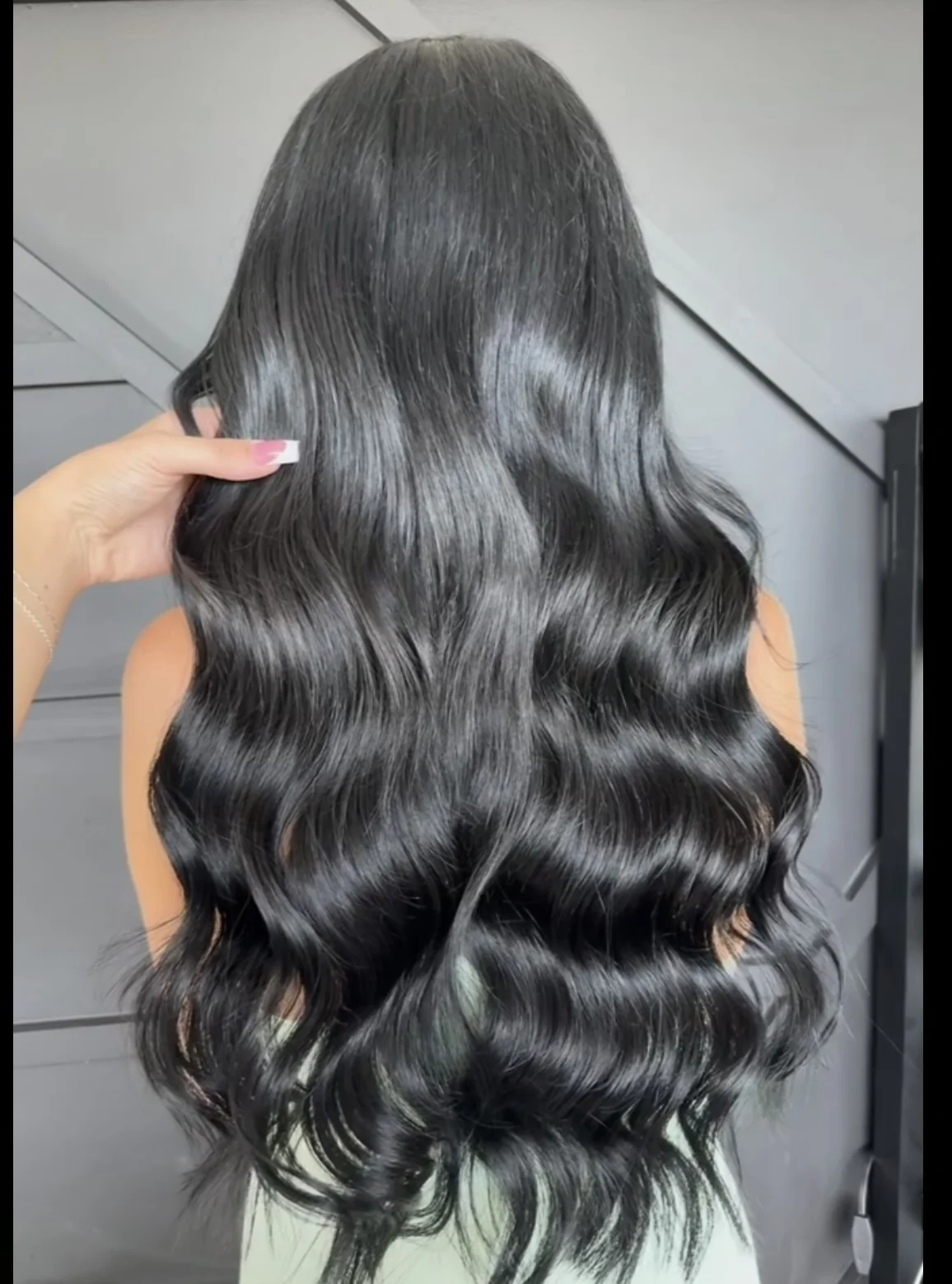 Glossy dark hair styled in flowing waves