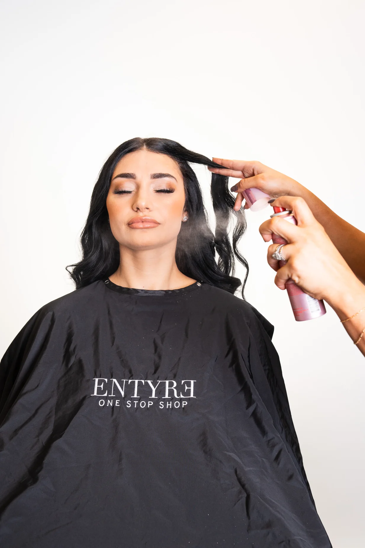 Hairstylist working on a polished occasion-ready look at the Entyre salon